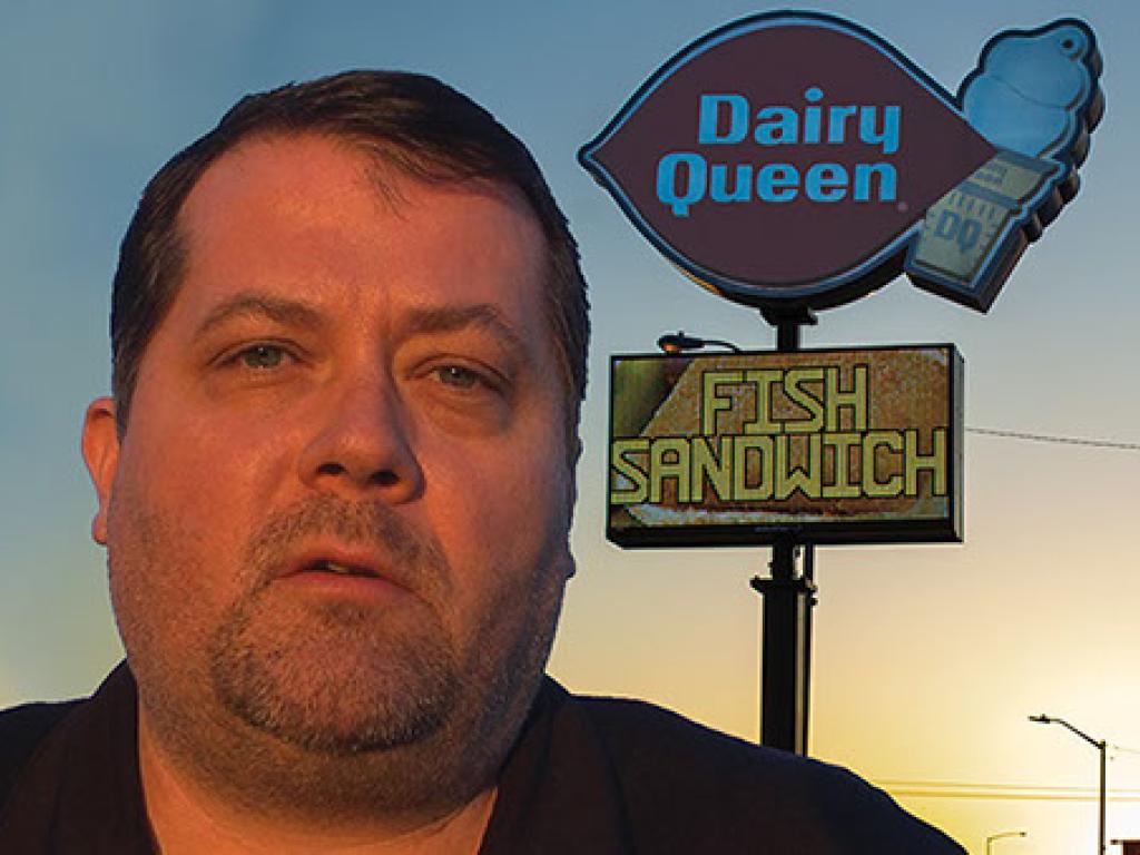 Dairy Queen LED single pole pylon sign with business owner in frame